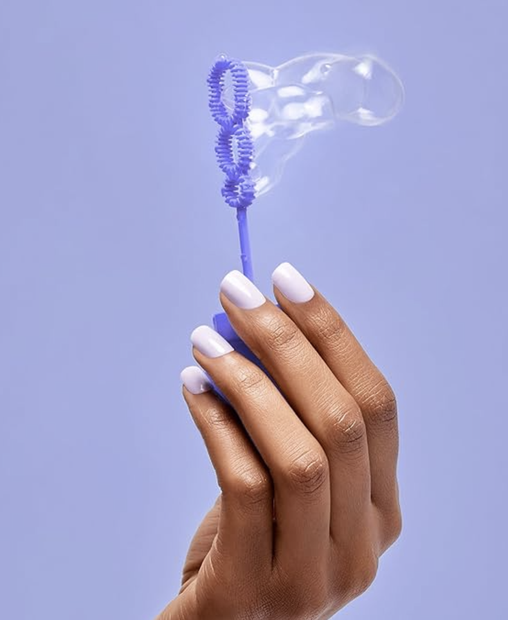 A hand holding bubbles, and had purple press ins by Kiss 